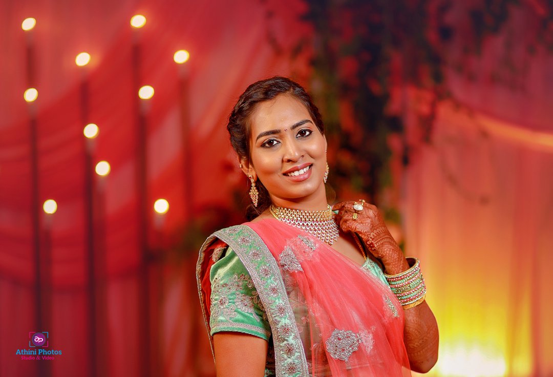 A stunning Indian bride wearing a pink sari, radiating beauty and elegance on her special day.