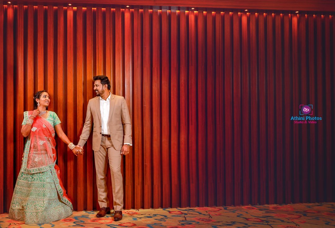 A couple wearing traditional Indian attire, showcasing the vibrant colors and intricate designs of their cultural clothing.