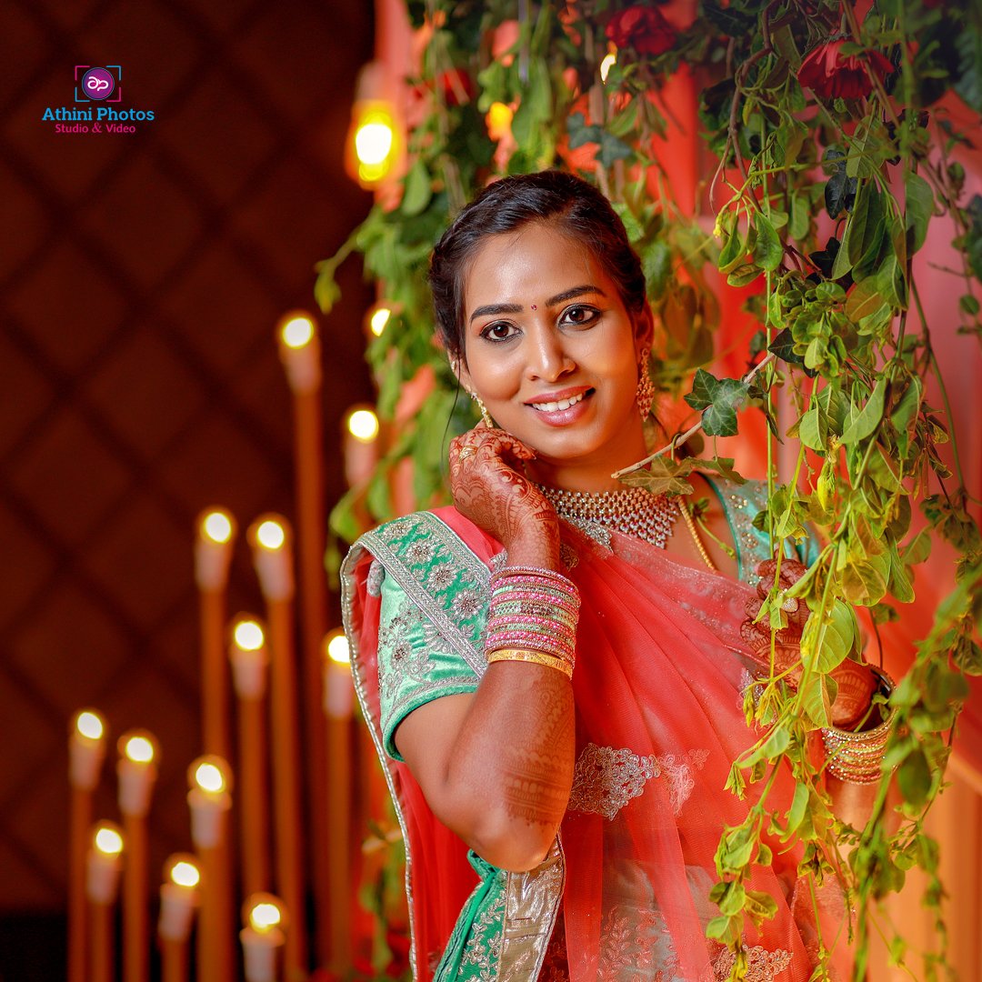 A stunning Indian bride in a sari, elegantly posing for the camera on her special day.
