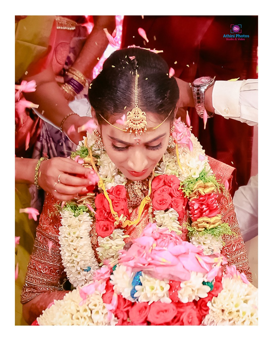 A bride sitting while her mother styles her hair for the wedding photoshoot.