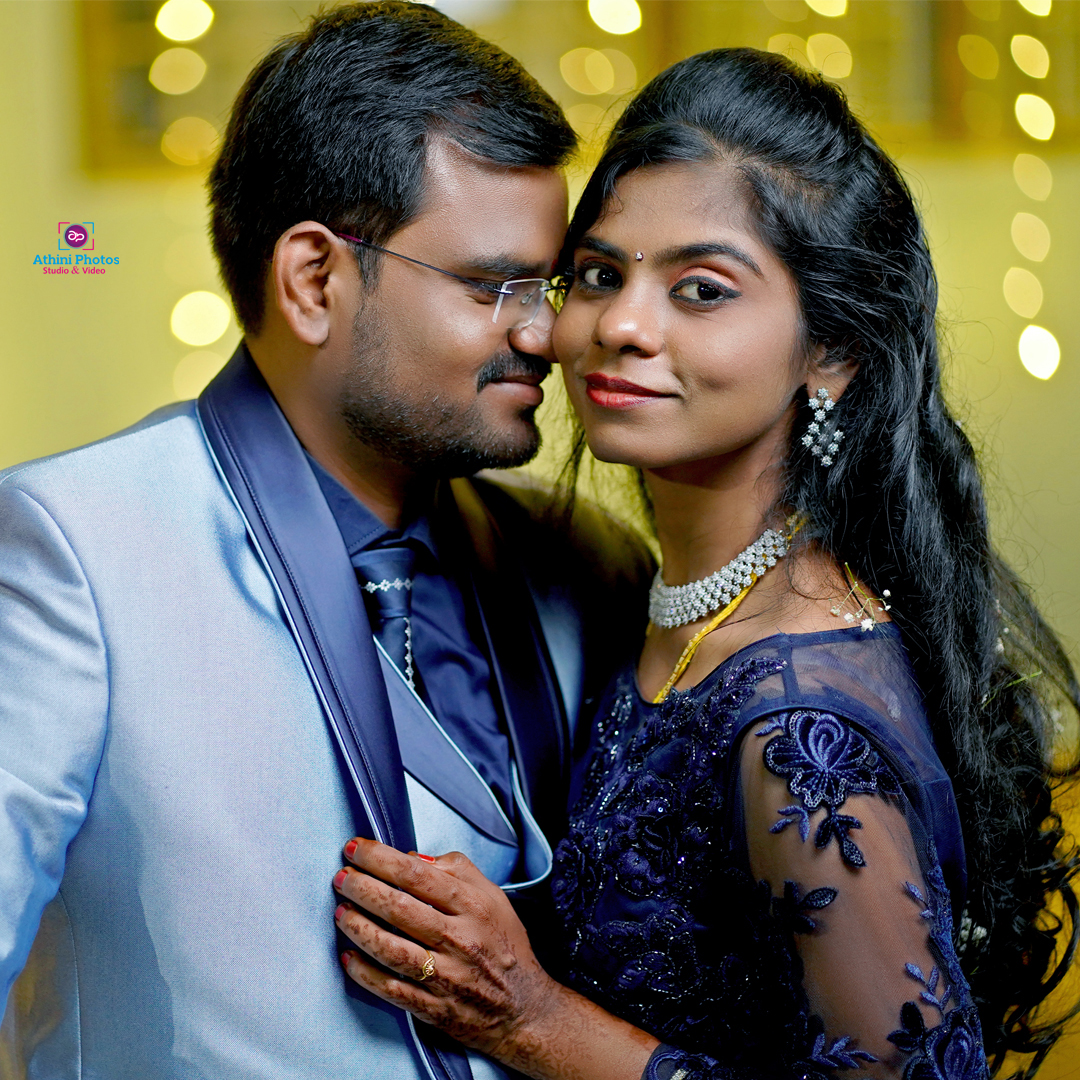 A beautiful bride and groom exchanging vows under a flower arch with their loved ones surrounding them.