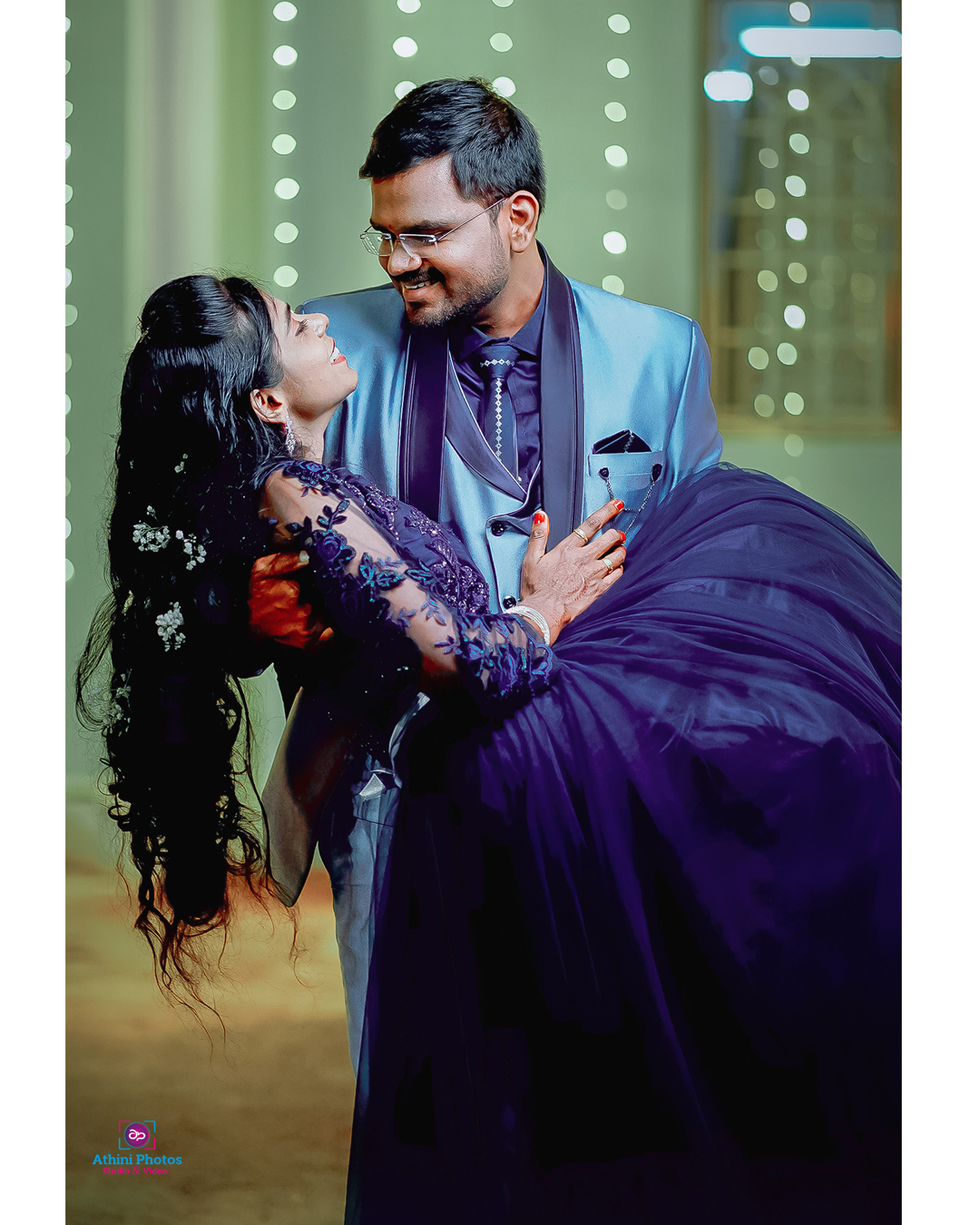 A beautiful bride and groom exchanging vows under a flower arch with their loved ones surrounding them.