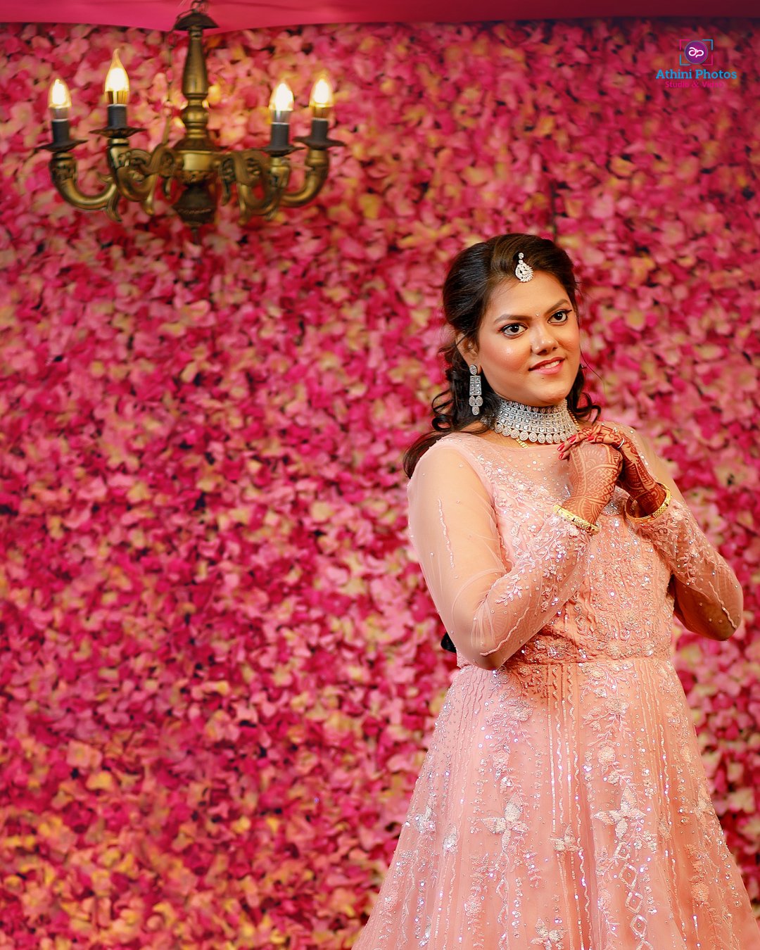 A beautiful bride in an elegant orange gown, striking a pose for the camera on her special day.