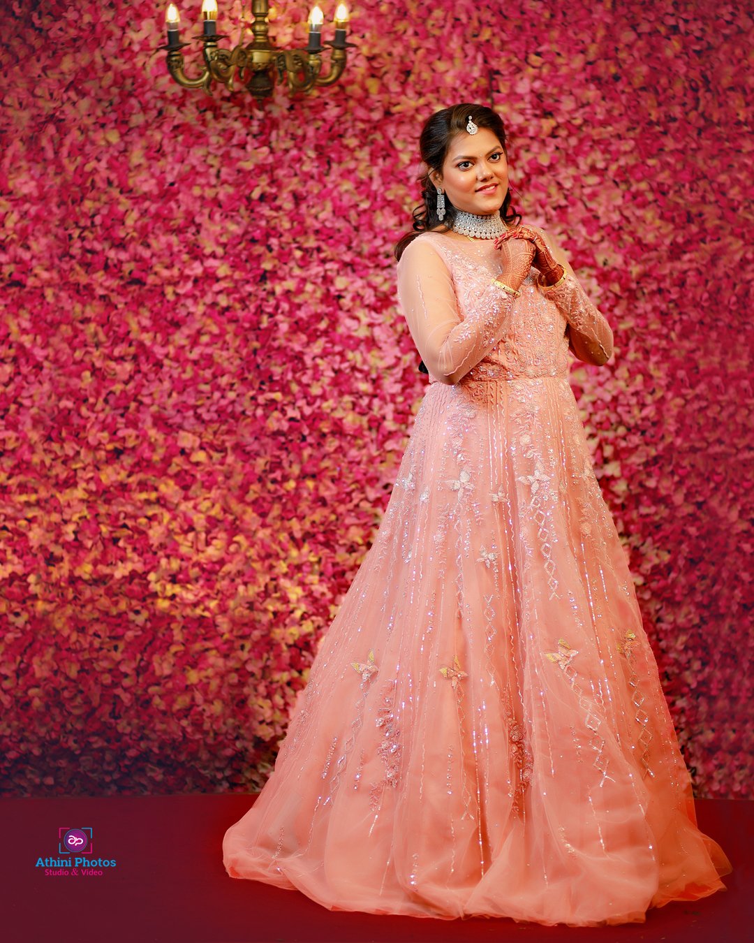 A beautiful bride in an elegant orange gown, striking a pose for the camera on her special day.