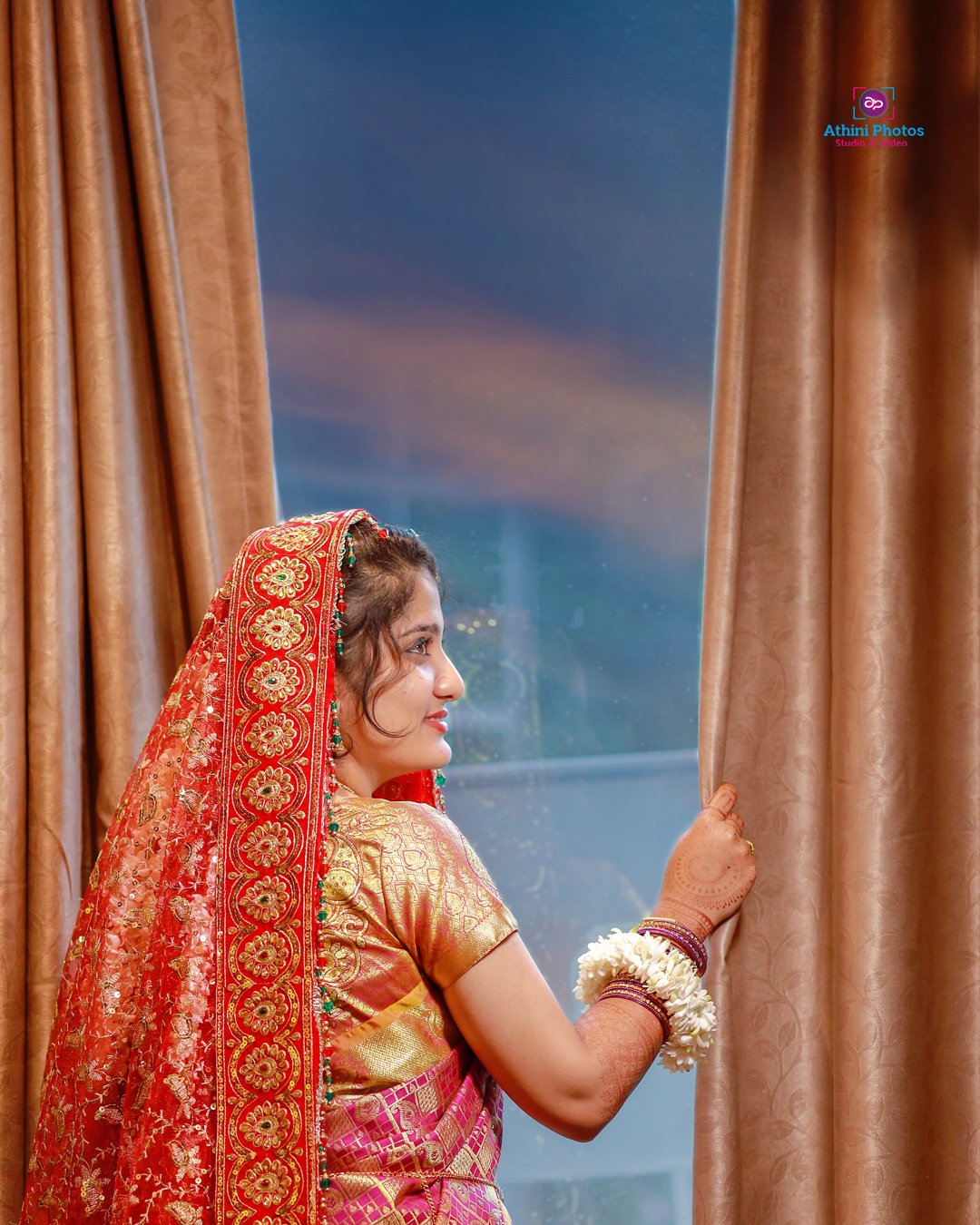 A Muslim bride wearing a traditional Indian wedding dress, adorned with intricate embroidery and jewelry.