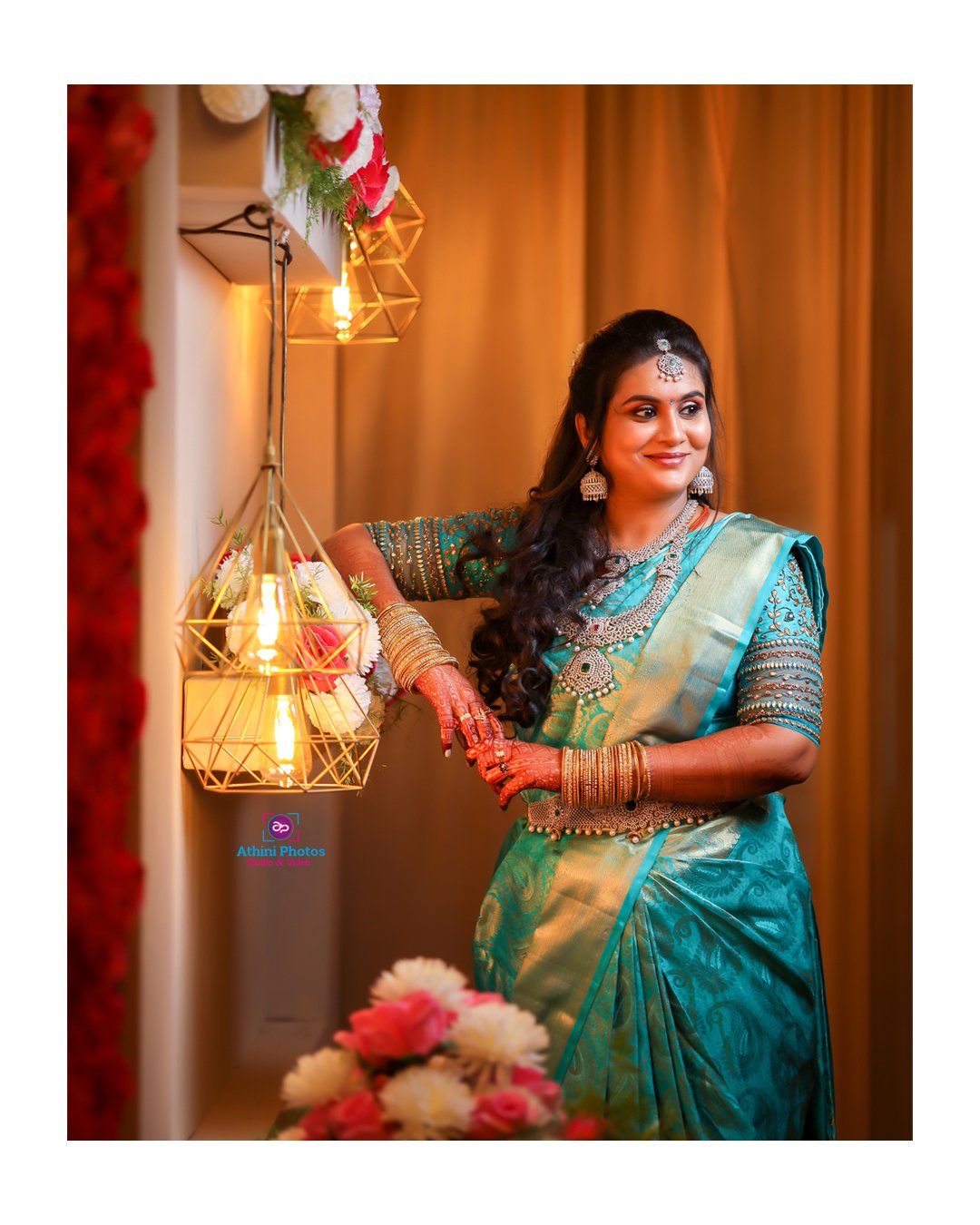 A stunning Indian bride in a blue sari posing for her wedding photoshoot.