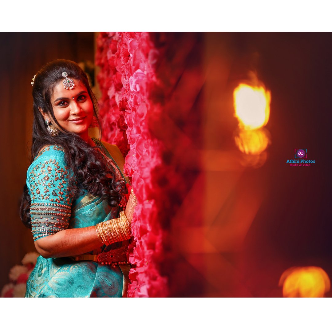 Beautiful Indian bride in traditional blue sari captured during wedding photoshoot.
