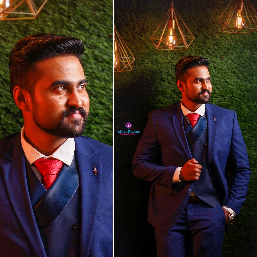  A stylish gentleman in formal attire standing beside a gramophone, capturing memories at a wedding photoshoot.