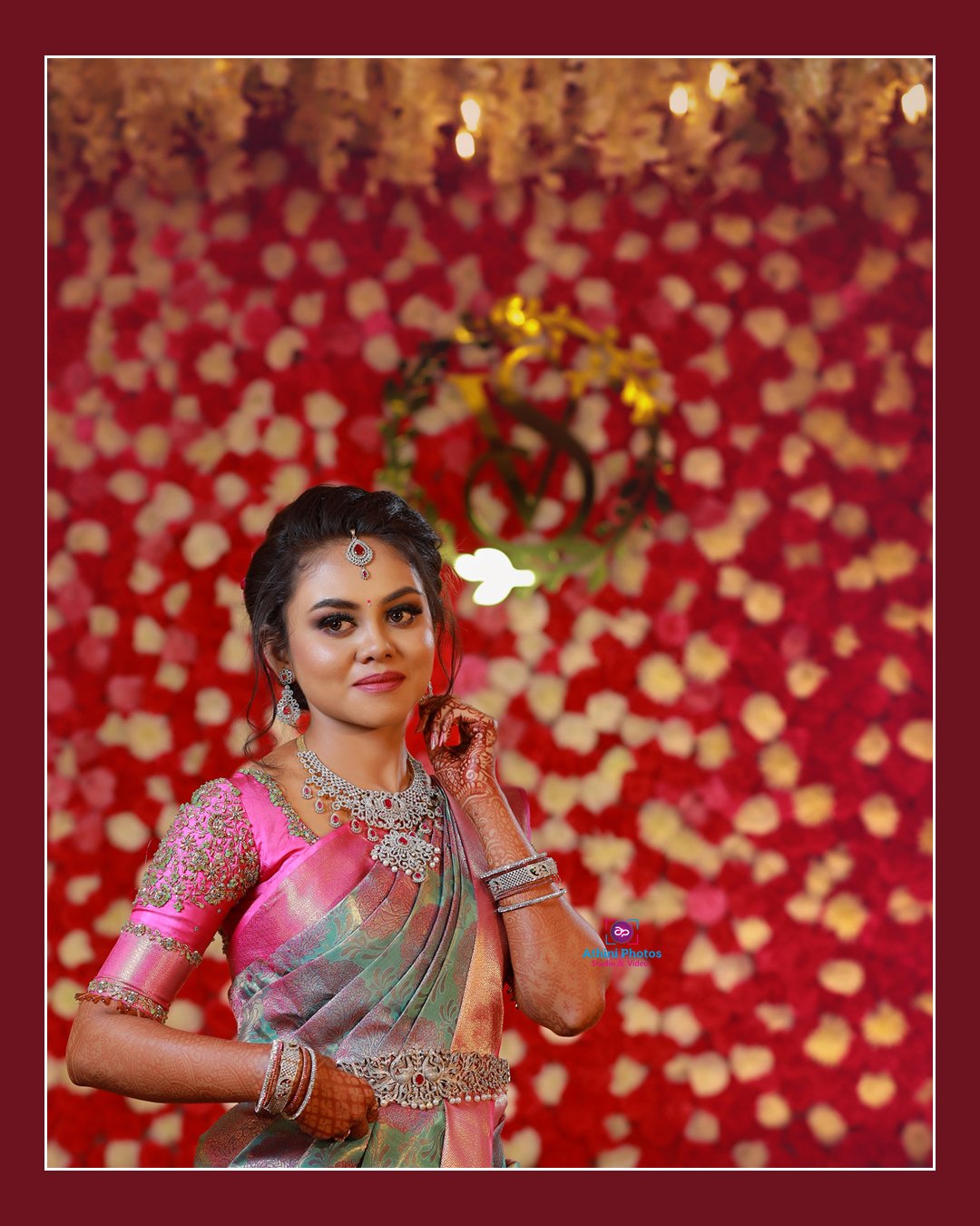 A stunning bride in a pink sari, radiating elegance and joy on her special day.